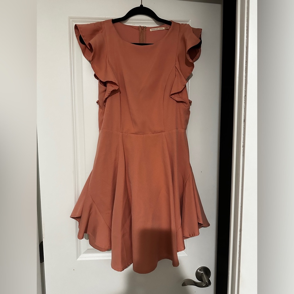 This cute peach colored dress with ruffle sleeves stole the show at a wedding.